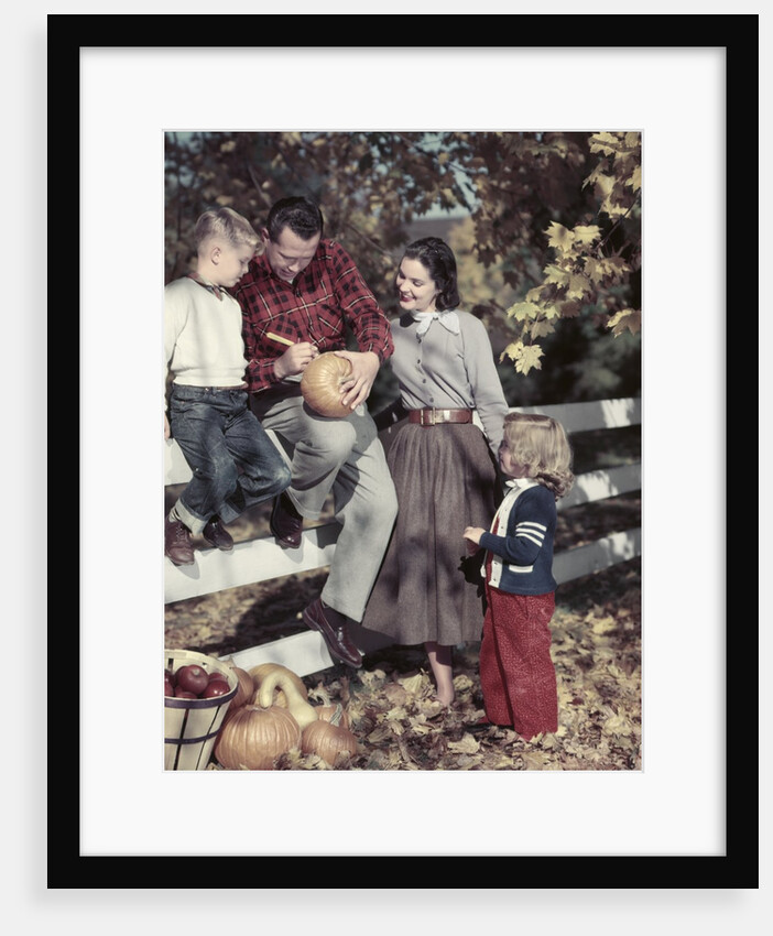 1950s Family Father Mother Son And Daughter Outdoor Carving A Pumpkin by Anonymous