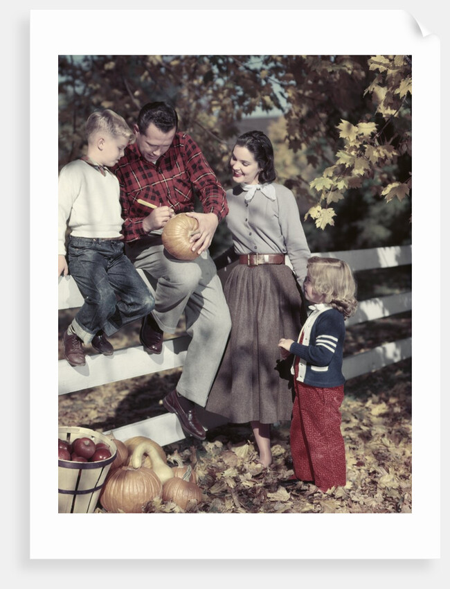1950s Family Father Mother Son And Daughter Outdoor Carving A Pumpkin by Anonymous