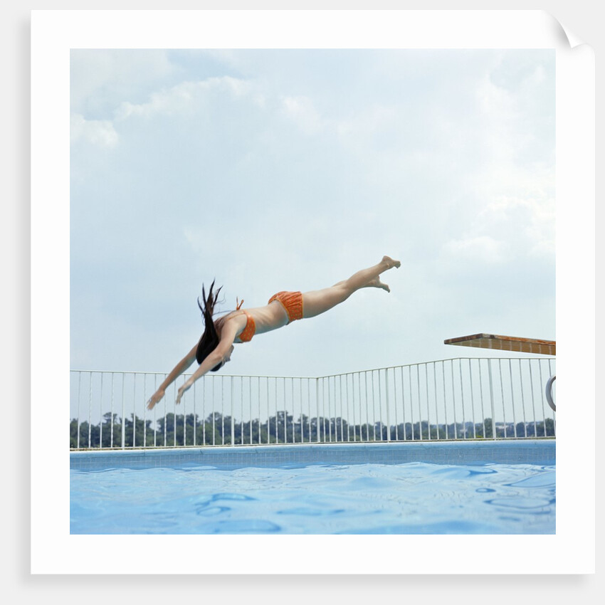1970s Teen Girl Diving Into Swimming Pool by Anonymous