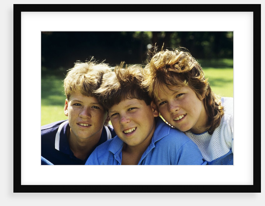 1980s Two Brothers And Their Sister Posed Heads Together Smiling Looking At Camera by Anonymous