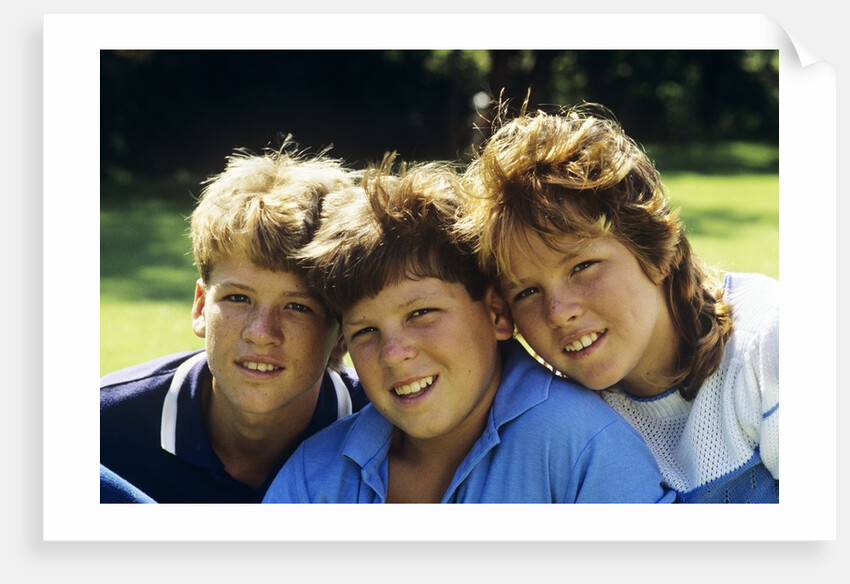 1980s Two Brothers And Their Sister Posed Heads Together Smiling Looking At Camera by Anonymous