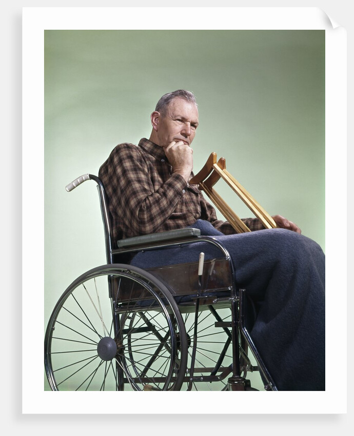 1960 1960s Retro Senior Man Sitting In Wheelchair With Crutches Blanket Wrapped Around Legs by Anonymous