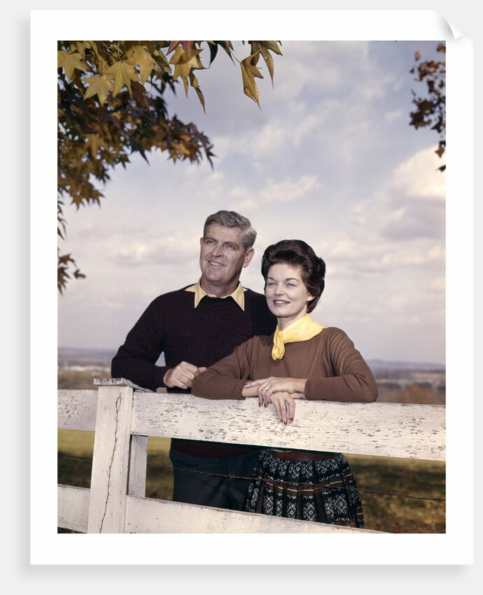 portrait Couple Husband & Wife Smiling Standing Together Behind White Board Fence Outdoor by Anonymous