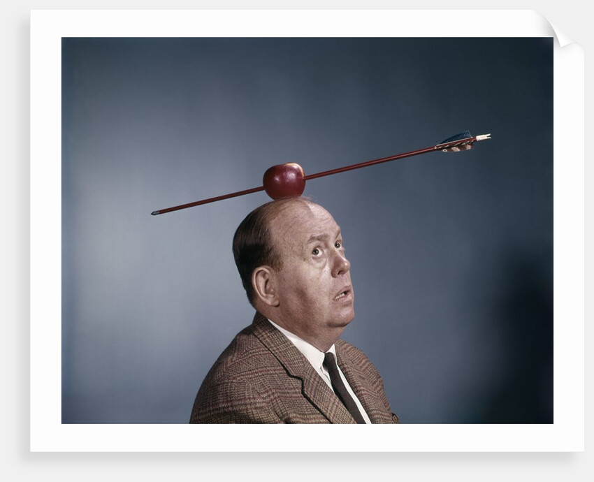 1960s Anxious Nervous Man Looking Up At Arrow Shot Through An Apple Sitting On Top Of His Head by Anonymous
