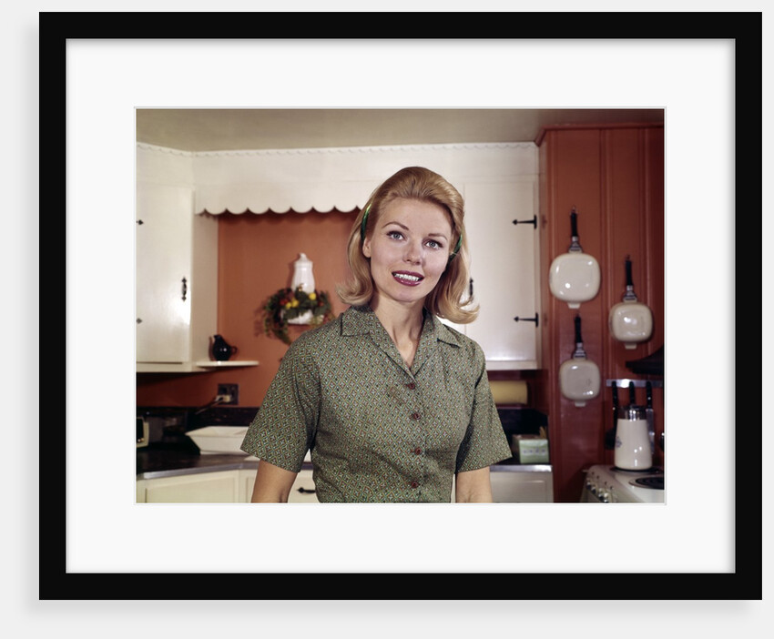 1960s Portrait Young Blonde Woman Housewife In Kitchen Smiling Looking At Camera by Anonymous