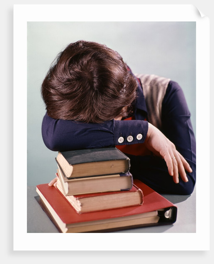 1960s 1970s Female Student Head Down On Pile Of Books Asleep Exhausted by Anonymous