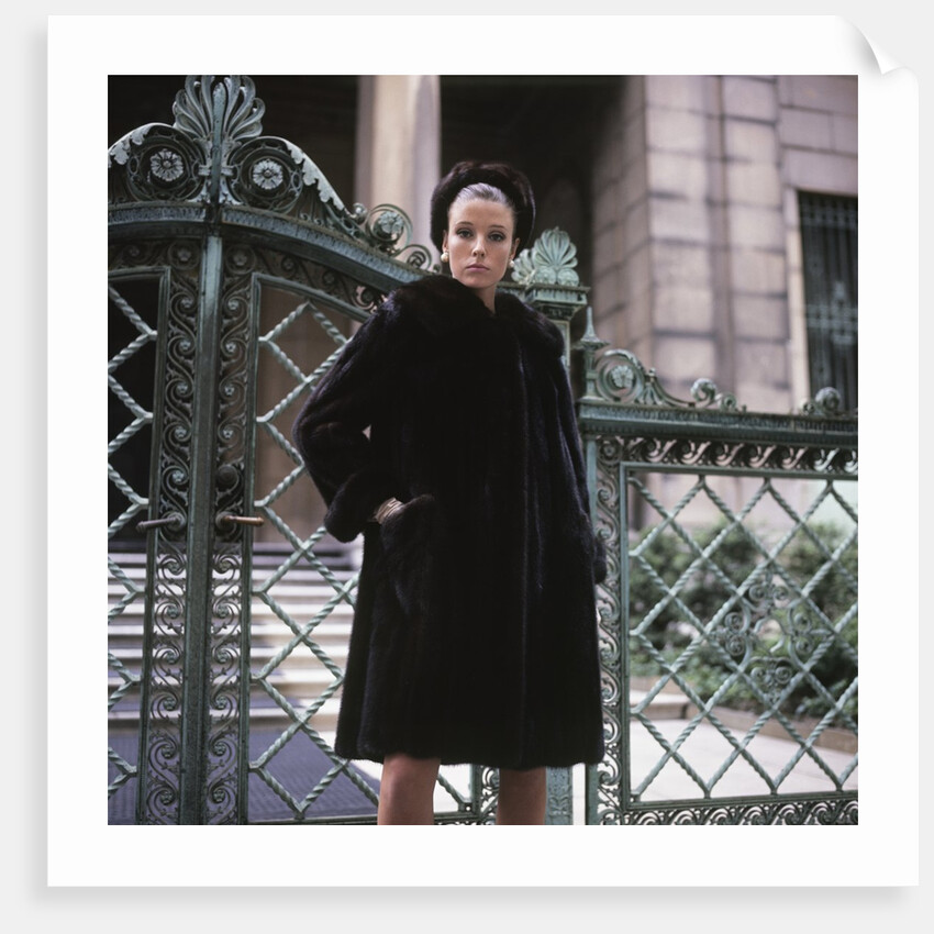 1960s Young Woman Wearing Dark Mink Coat Hat Standing Ornate Wrought Iron Gate Fur Retro by Anonymous