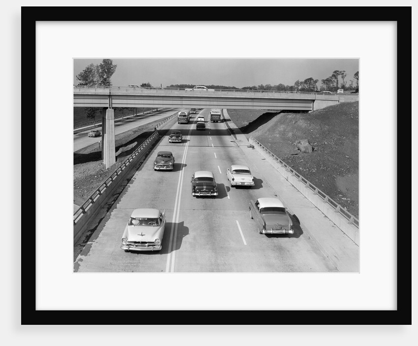 1950s Cars Automobiles Driving On Highway Under Overpass by Anonymous