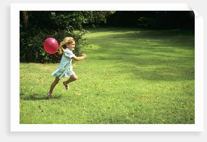 1980s Little Girl With A Red Balloon Running In The Grass by Anonymous