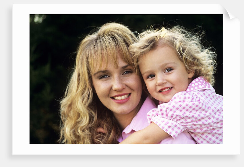 1990s Portrait Of Mother And Daughter Outdoors Looking At Camera Wearing Pink Shirts by Anonymous