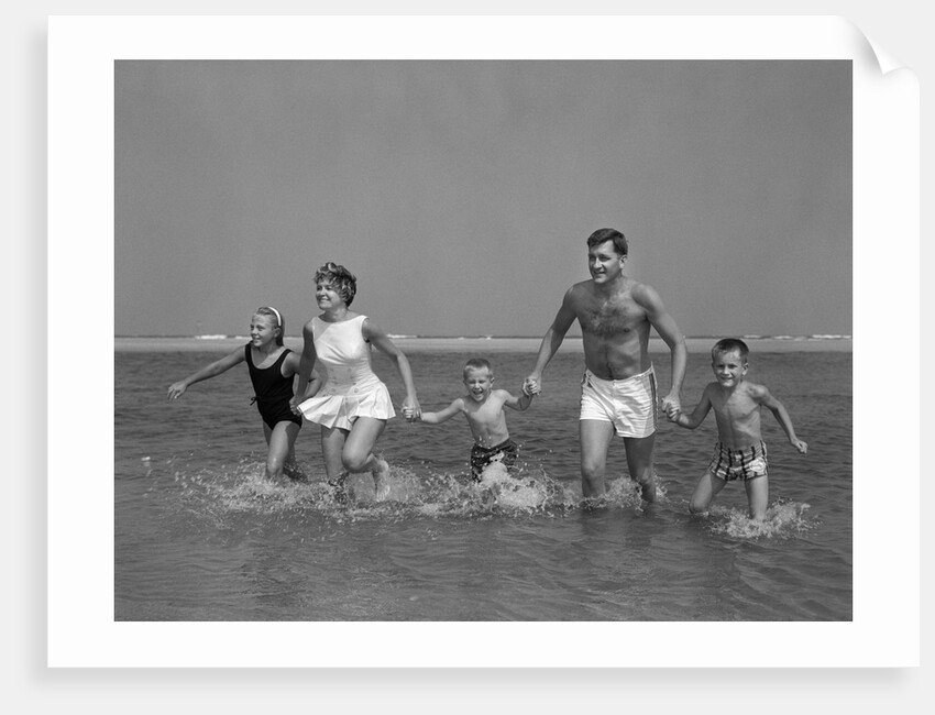 1960s Family Holding Hands Running Together In Water At Seashore by Anonymous