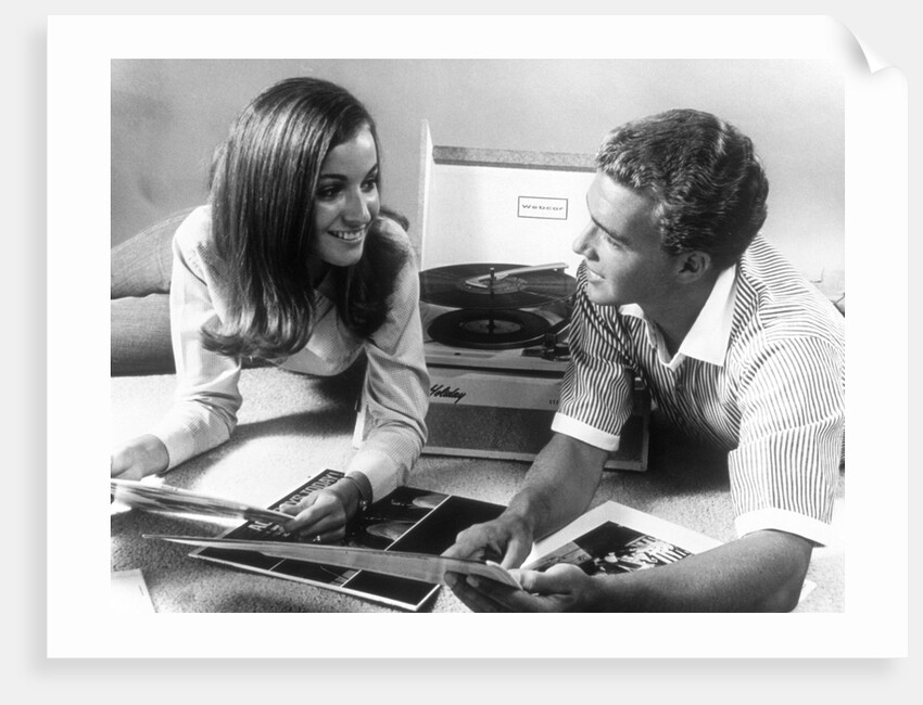 1960s Teen Couple Playing Lp Vinyl Records On Portable Phonograph by Anonymous