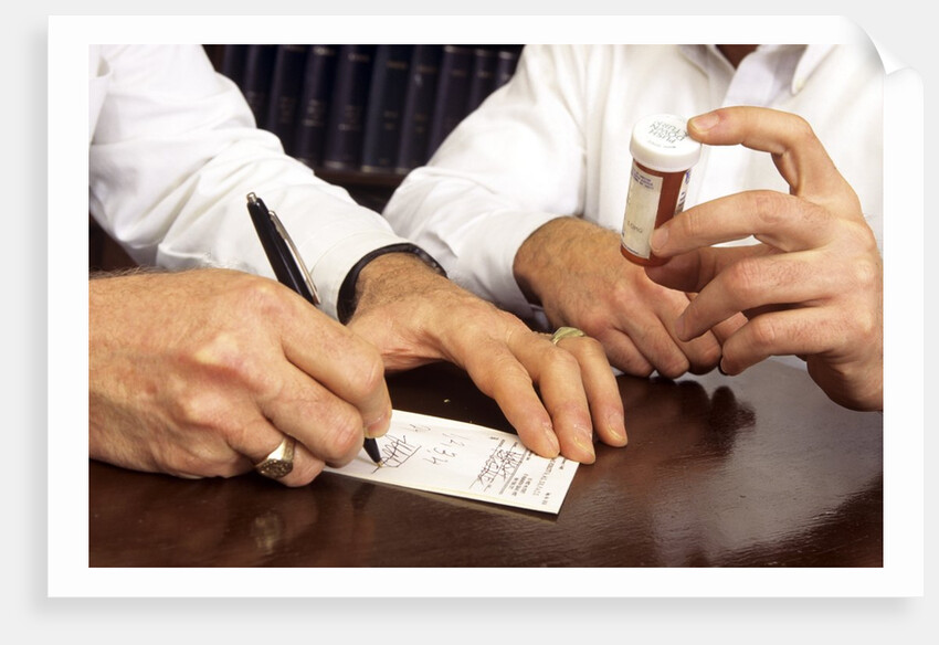 1990s Doctor Writing Refill Prescription For Patient Holding Pill Bottle by Anonymous