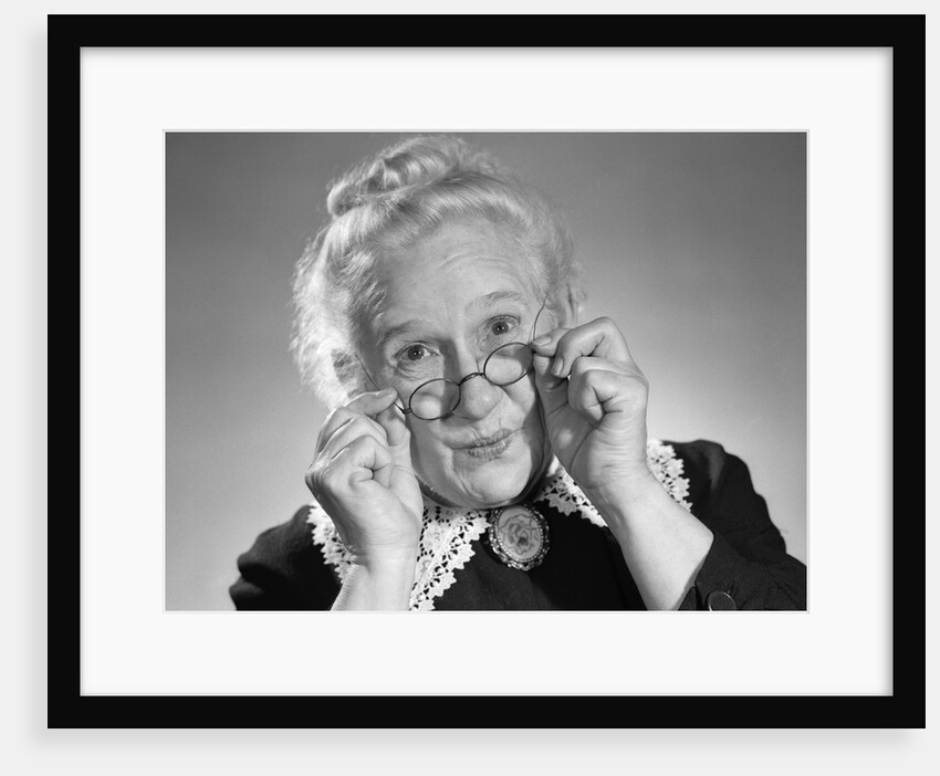 1950s Portrait Of Smiling Old Lady Holding Her Antique Wire Frame Glasses by Anonymous