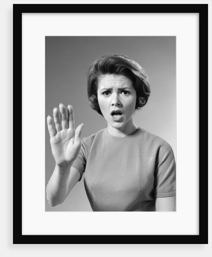 1960s Alarmed Woman Holding Up Her Hand To Stop Something by Anonymous