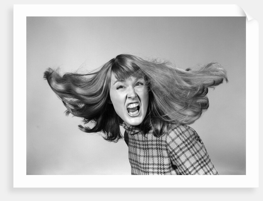 1960s Angry Woman Yelling Gnashing Teeth Hair Flying Looking At Camera by Anonymous