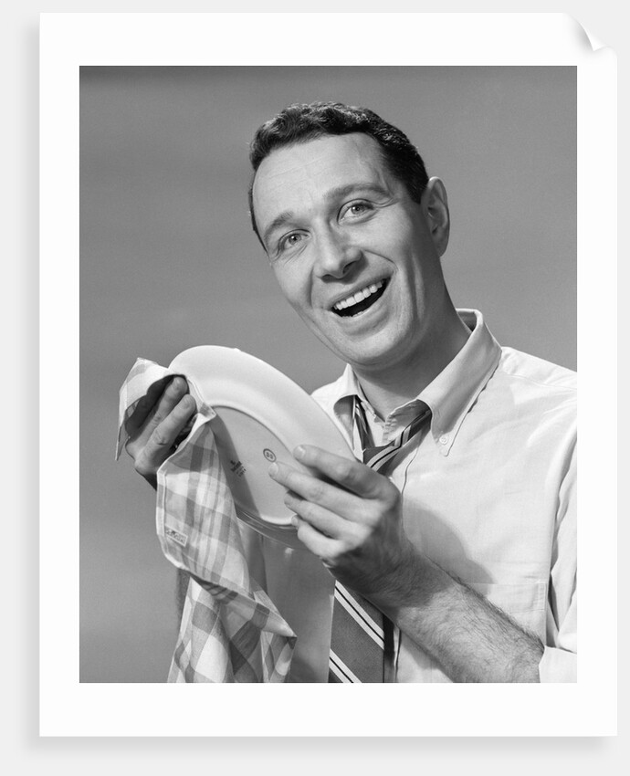 1950s Smiling Man Drying Plate With Dish Towel Looking At Camera by Anonymous