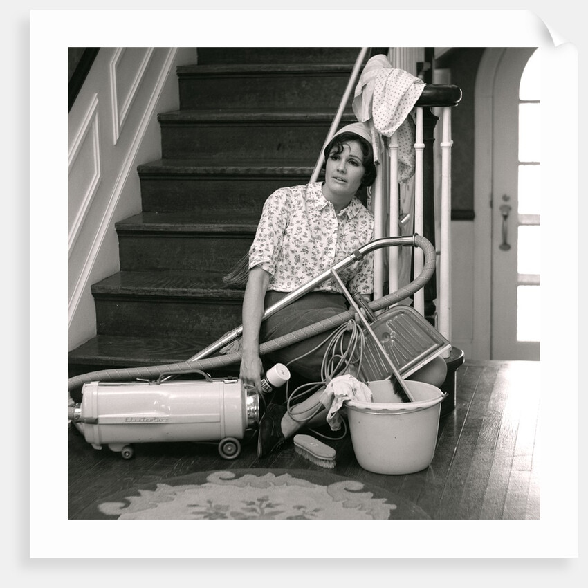 1960s 1970s Exhausted Housewife Sitting At Bottom Of Stairs Surrounded By House Cleaning Equipment by Anonymous