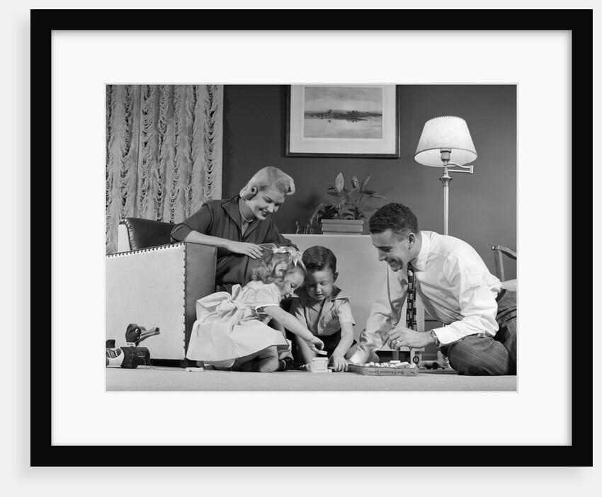 1950s Family Of 4 Gathered In Living Room Playing With Letter Blocks by Anonymous
