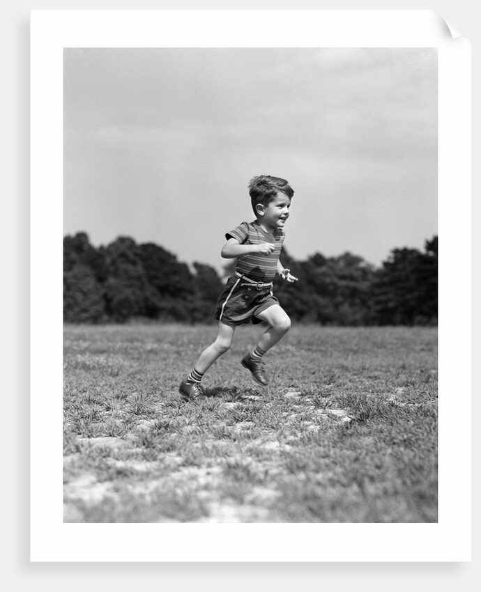 1940s Little Boy Running Playing On Grassy Field by Anonymous