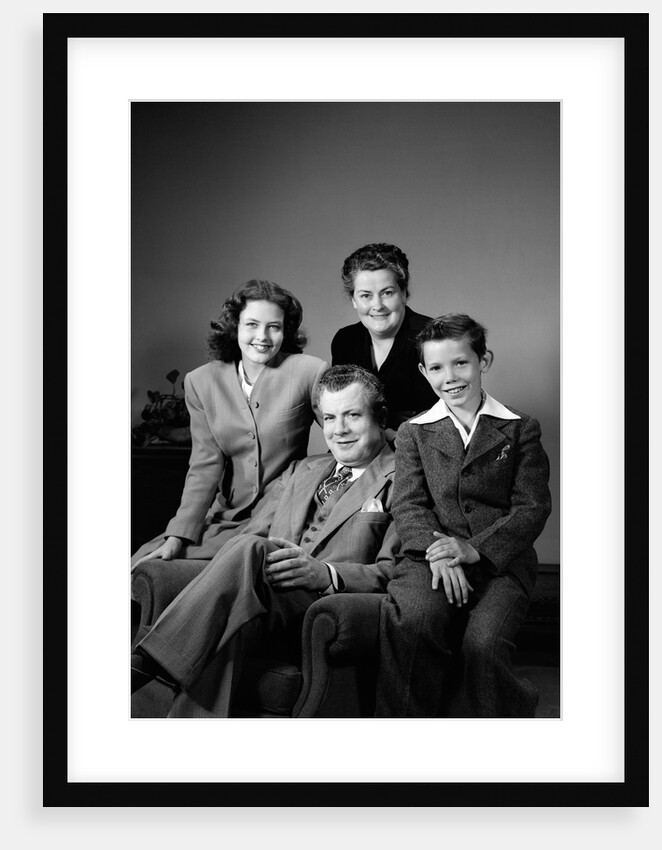 1940s Portrait Family Mother Father Daughter Son Sitting Together On Chair Studio by Anonymous