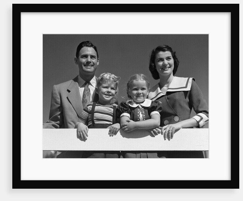 1950s Portrait Smiling Family Father Mother Daughter Son Standing Together Behind White Fence Outdoor by Anonymous