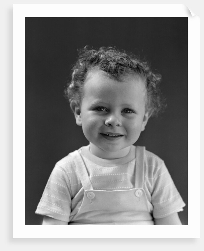 1940s Curly Haired Little Boy Portrait Smiling Looking At Camera by Anonymous