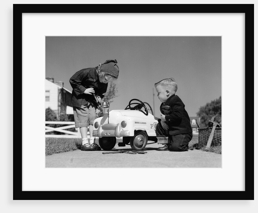 1950s Boy And Girl Playing At Repairing Toy Car by Anonymous