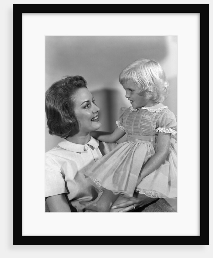 1960s Mother Holding Little Blond Girl Wearing Fancy Dress In Her Arms Looking At Each Other by Anonymous