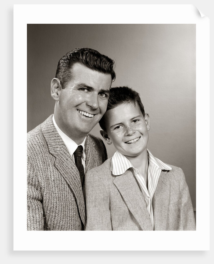 1950s Studio Portrait Smiling Man Father And Boy Son Sitting Together Looking At Camera by Anonymous