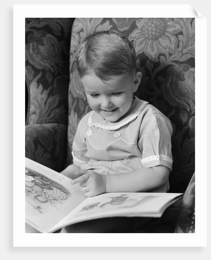 1930s 1940s Little Boy Sitting On Chair Reading Picture Book by Anonymous