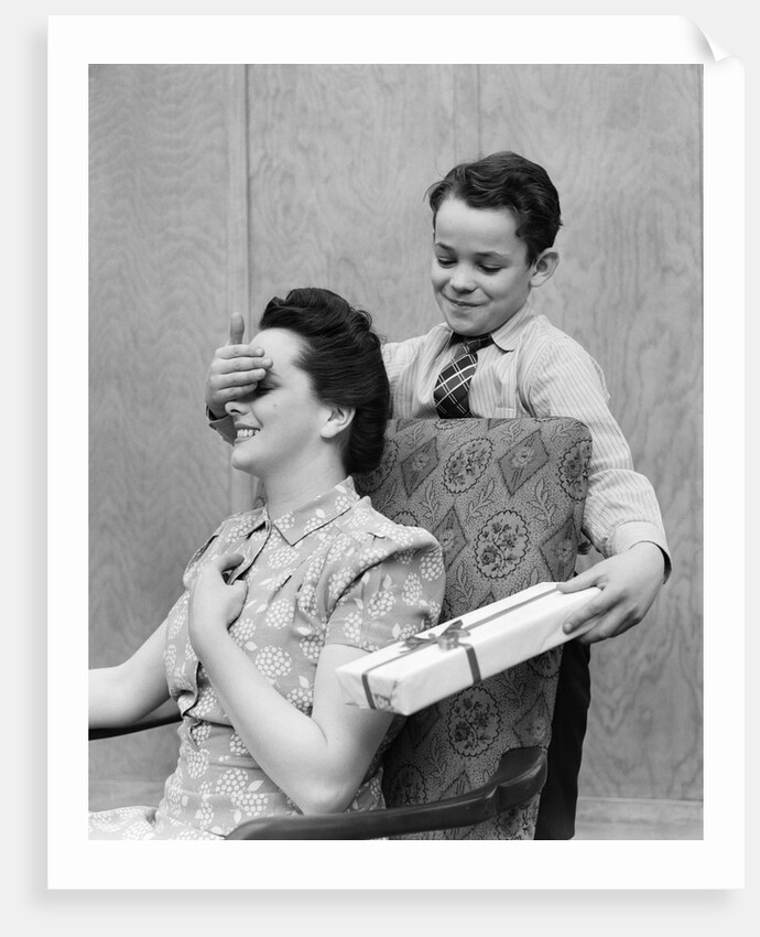 1930s 1940s Boy Son Surprising Woman Mother With Gift Wrapped Present by Anonymous