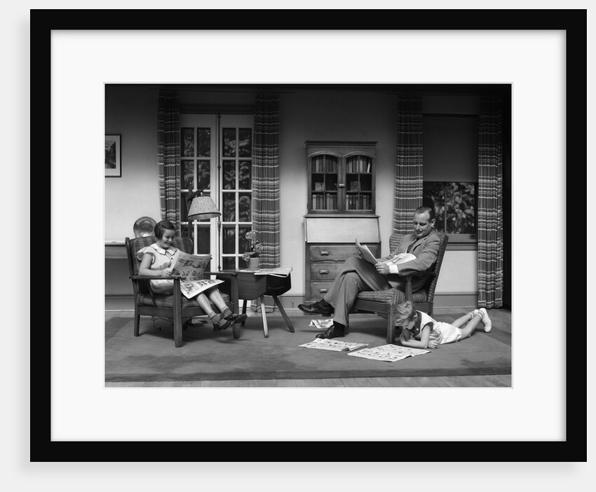 1930s Man Father Reading Newspaper Boy Son Girl Daughter Reading Sunday Comics In Living Room by Anonymous
