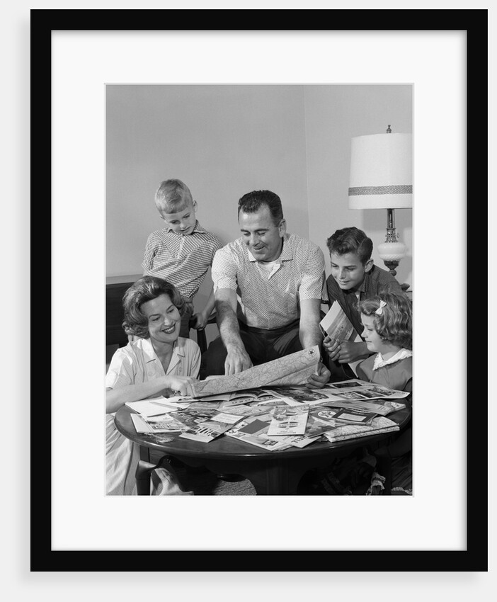 1960s Happy Family Father Mother Two Sons One Daughter Planning Trip Looking At Maps by Anonymous