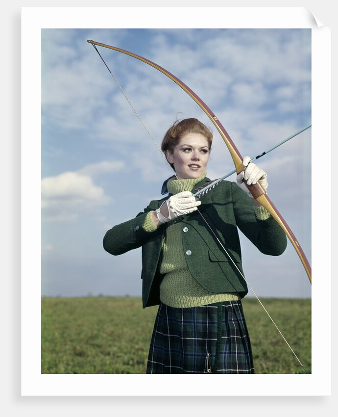 1960s 1970s Sports Woman Archer Holding Bow Preparing To Draw Arrow by Anonymous