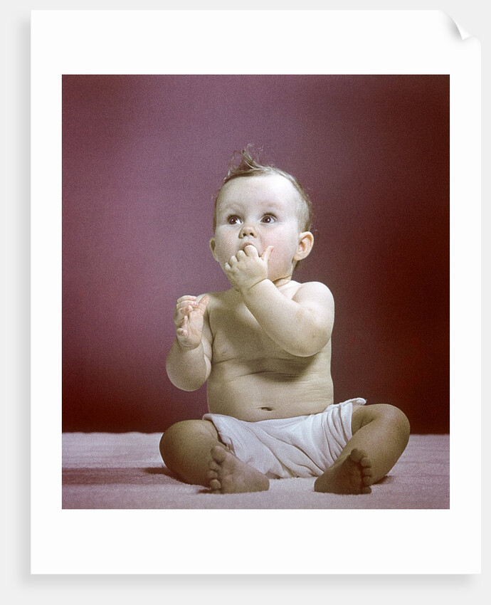 1940s 1950s Baby Diaper Sitting Looking Up Fingers In Mouth by Anonymous