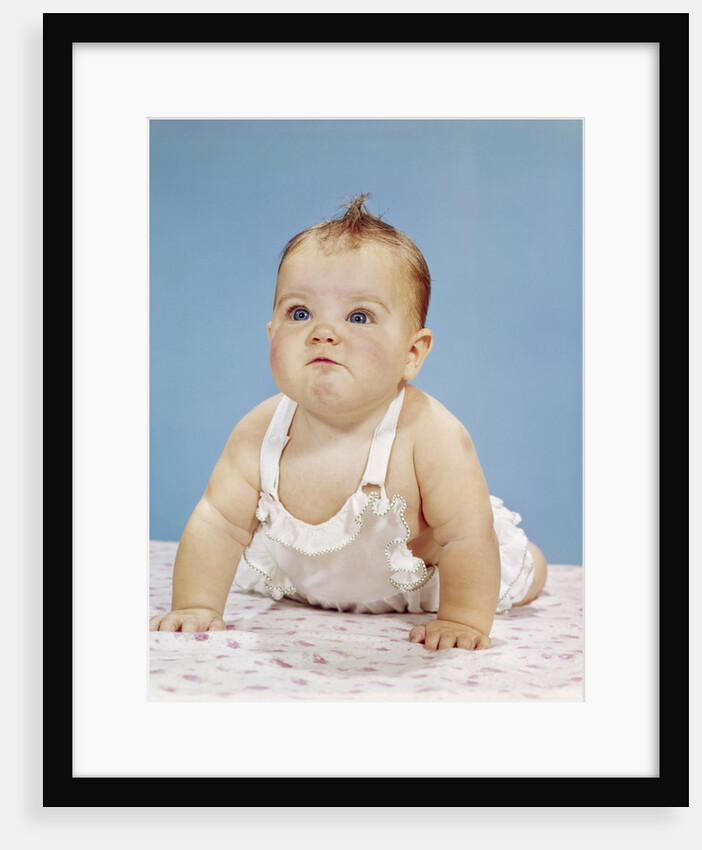 1960s Baby Making Funny Face Pushed Up On Arms Crawling Forward by Anonymous