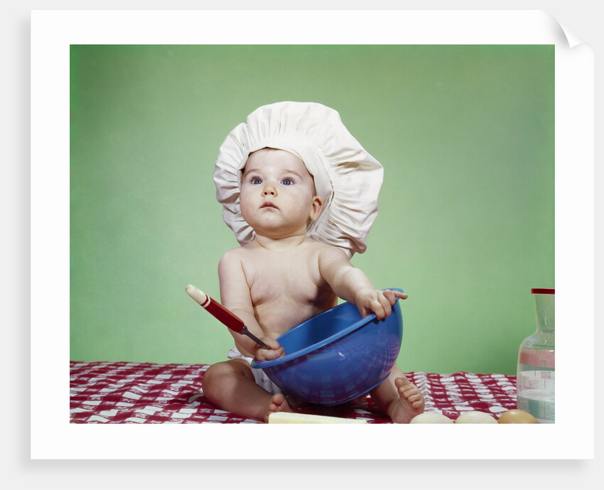 1960s Serious Baby In Chef Hat With Mixing Bowl And Spoon by Anonymous