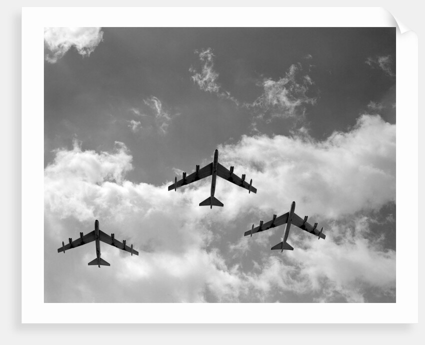 1950s three B-52 bomber airplanes in flight formation by Anonymous