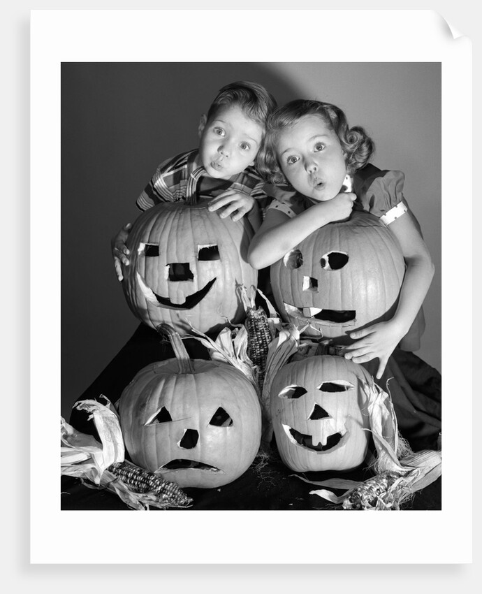 1950s boy and girl with four jack-o-lanterns by Anonymous