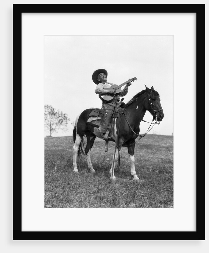 1920s cowboy on horse singing and playing guitar by Anonymous