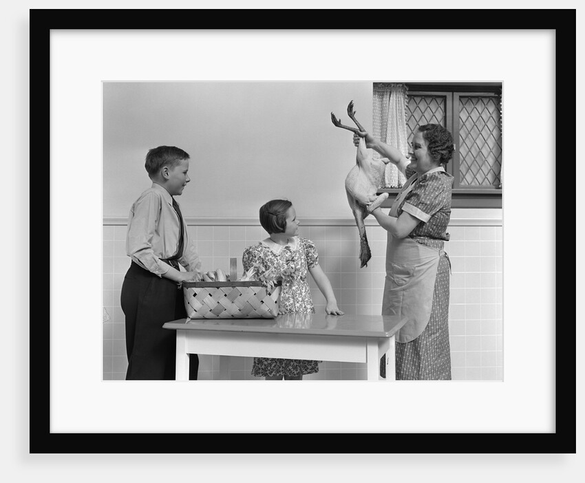 1940s housewife in kitchen showing plucked turkey to children by Anonymous