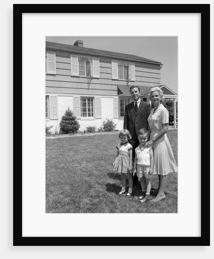1960s family portrait in front of suburban home by Anonymous