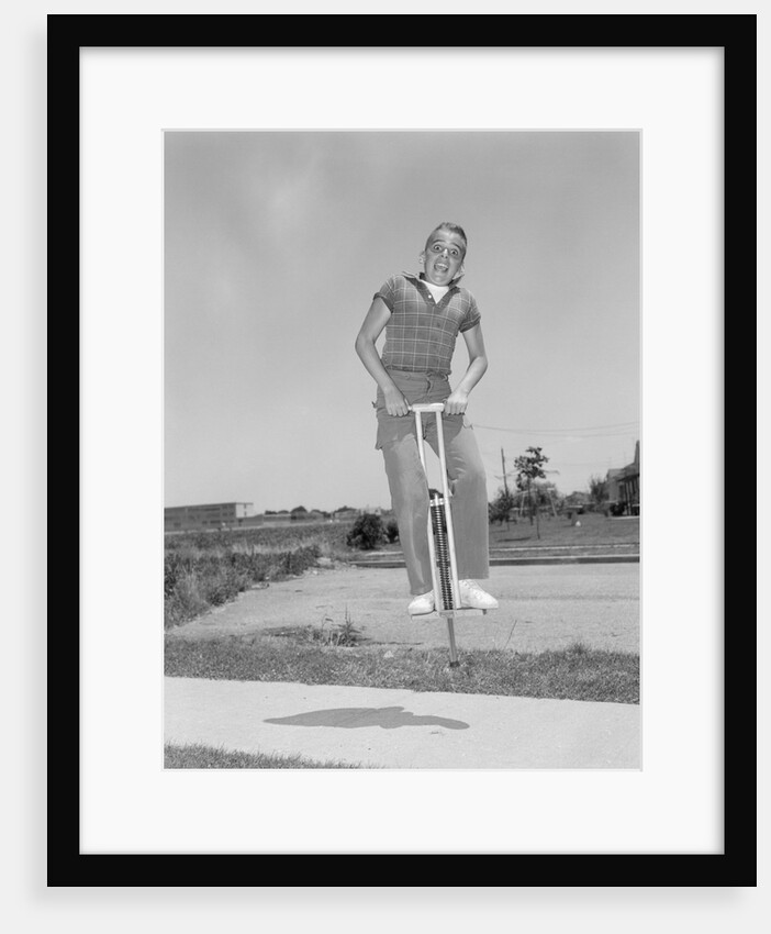1950s boy jumping on pogo stick by Anonymous