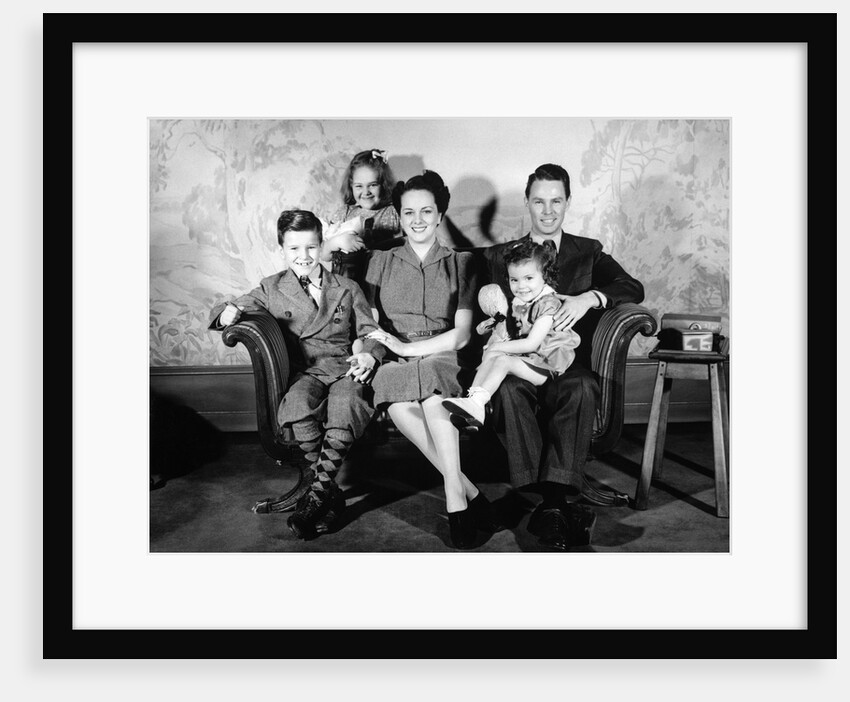 1930s 1940s family of five on a couch by Anonymous