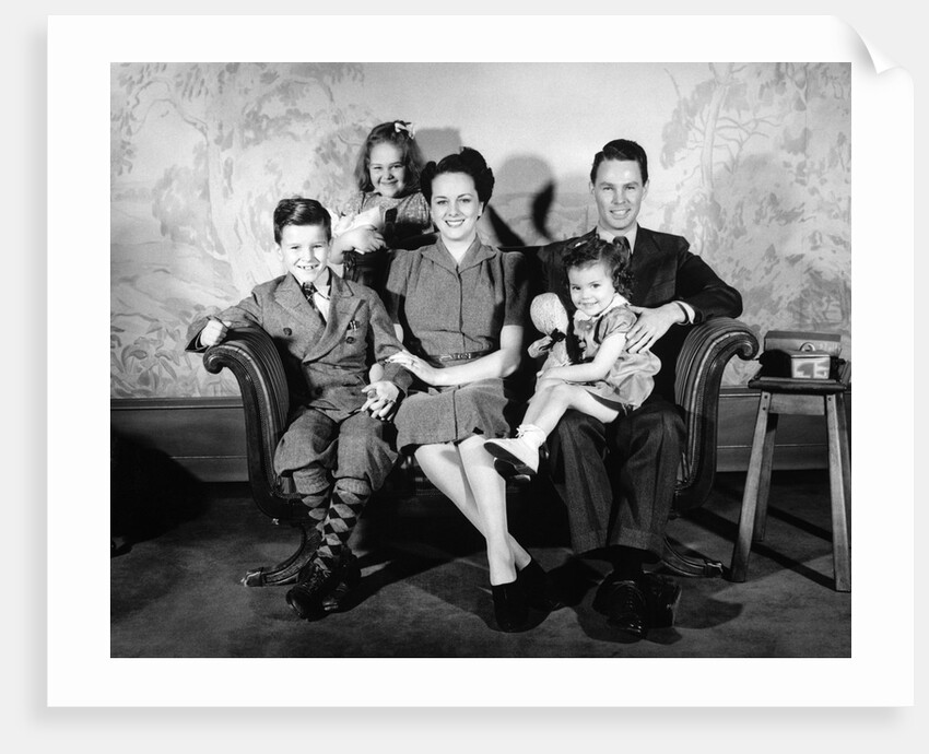 1930s 1940s family of five on a couch by Anonymous