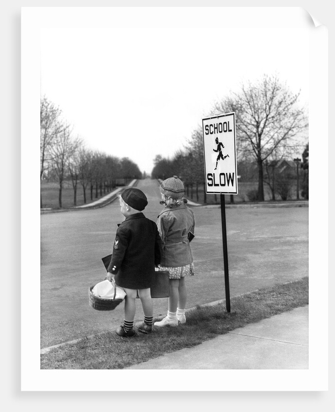 1930s 1940s boy and girl waiting to cross the road by Anonymous