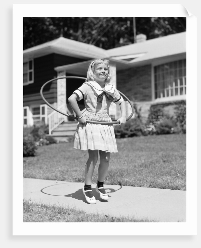 1950s girl on suburban sidewalk playing with a hula hoop by Anonymous