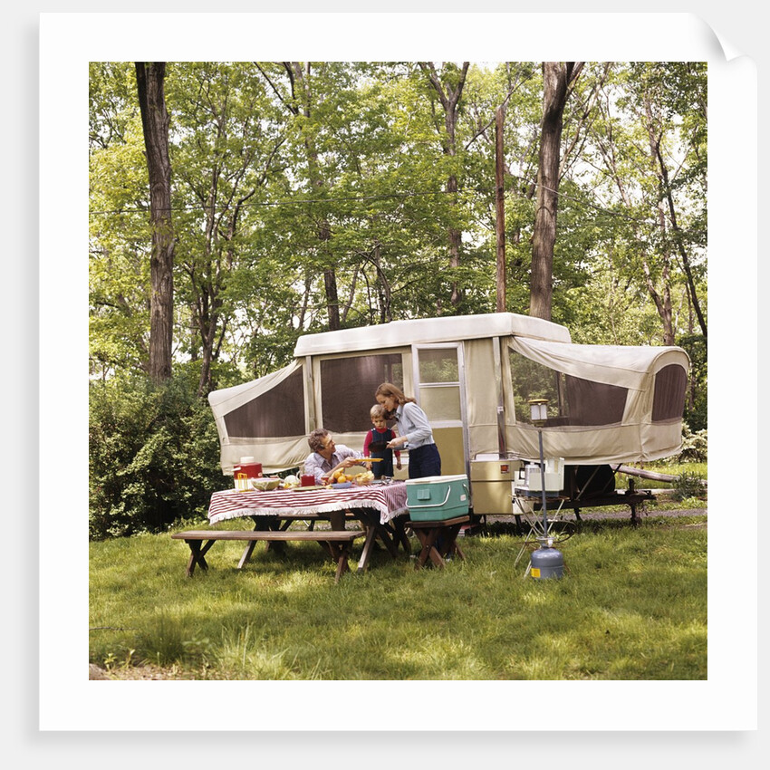 1970s family having picnic by camper by Anonymous