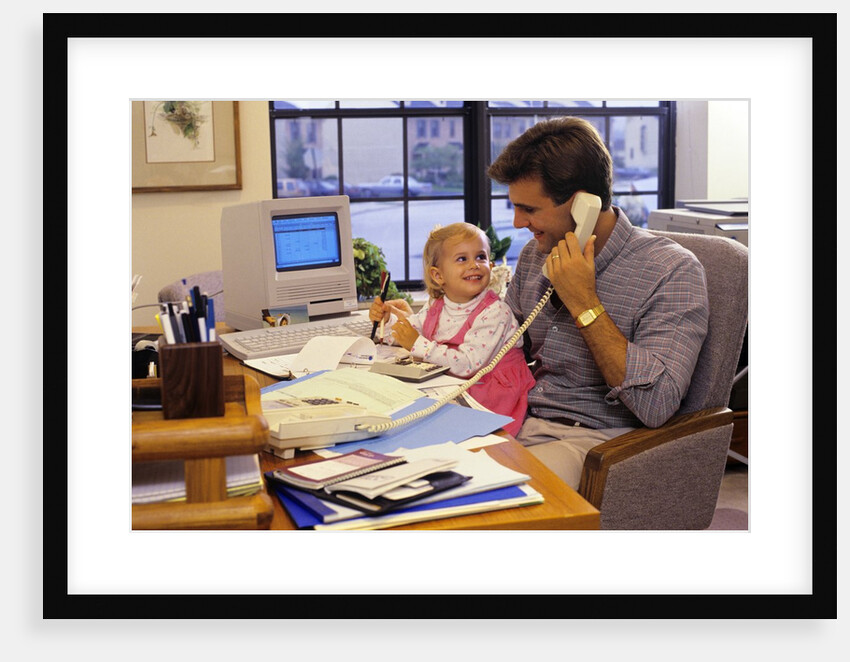 Father with young daughter in home office by Anonymous